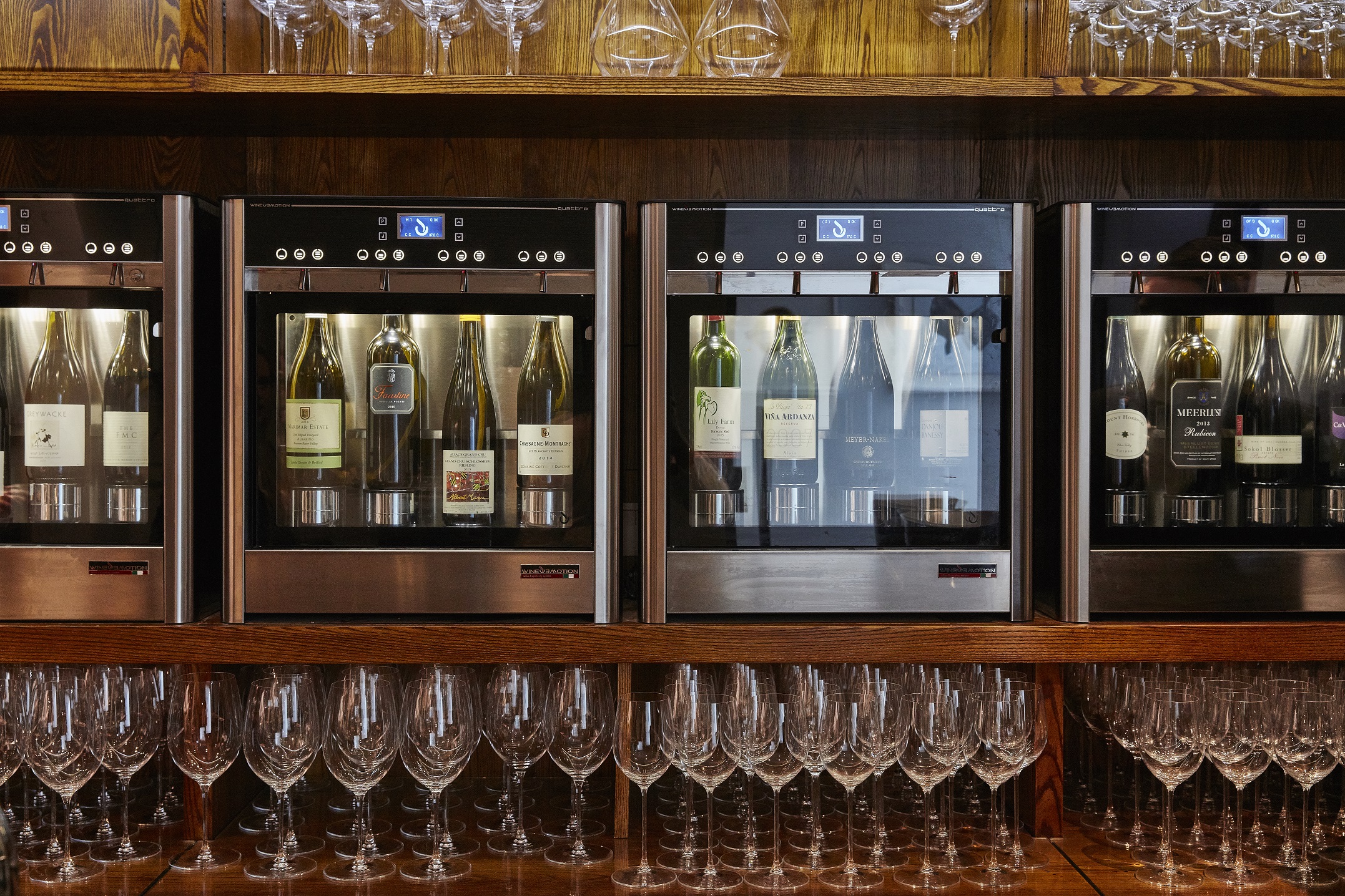 Lympstone Manor Wine Room showing wine bottles, wine system and glasses