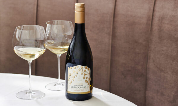 Lympstone Manor Chardonnay displayed with two wine glasses