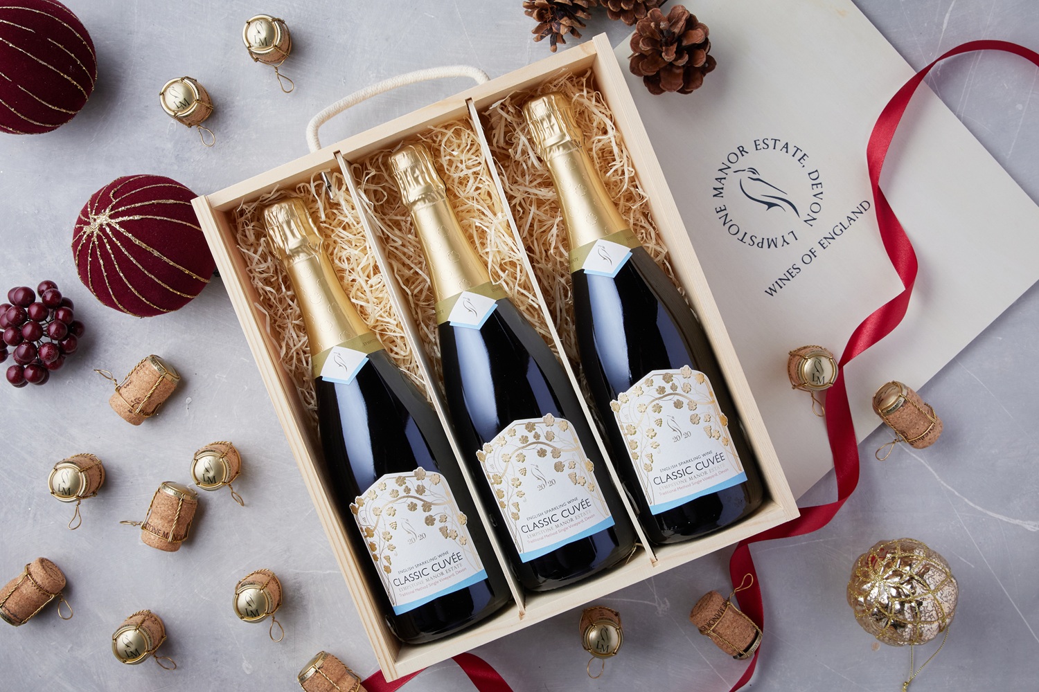 Cuvee bottles in a gift box displayed with Christmas decorations