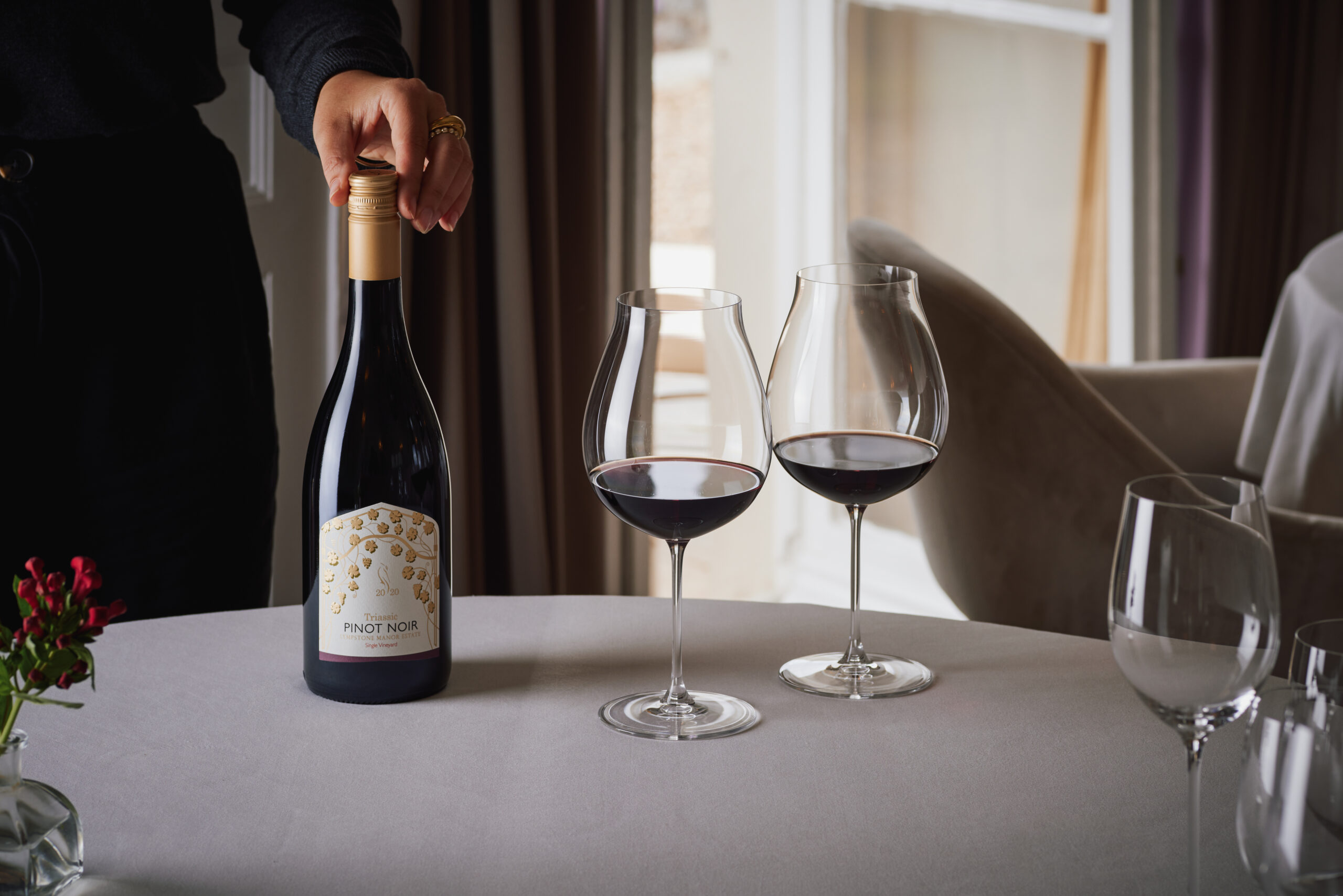 Lympstone Manor Triassic Pinot Noir served in two wine glasses with Christmas decoration